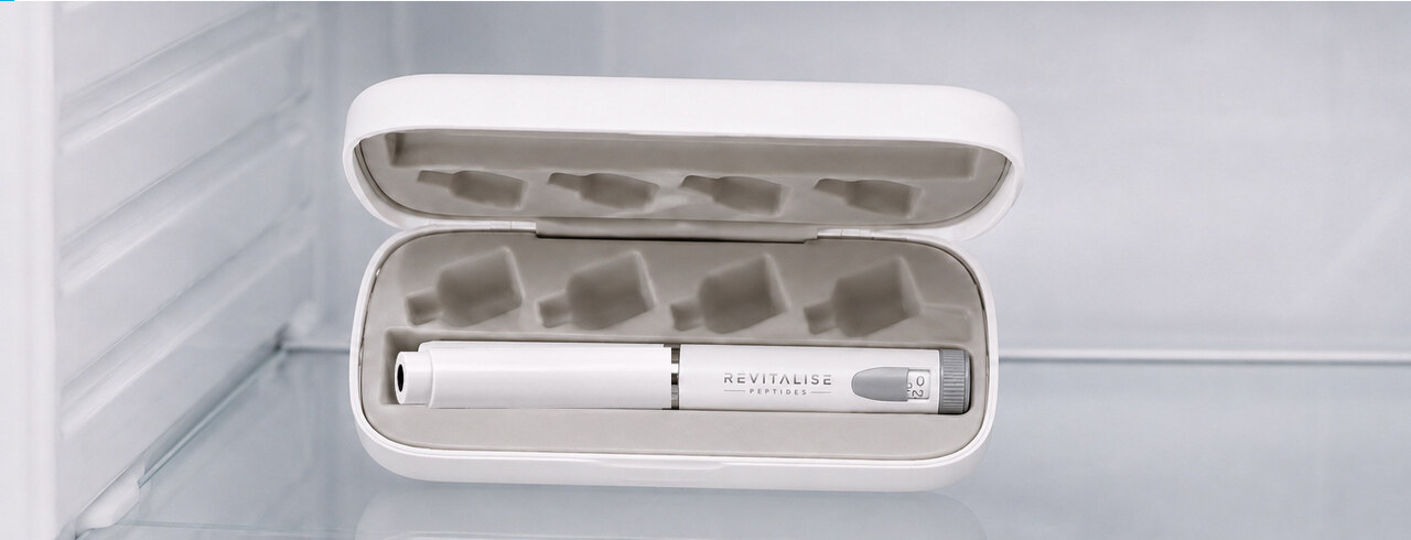 The capped Revitalise pen lying inside its open white case on a refrigerator shelf